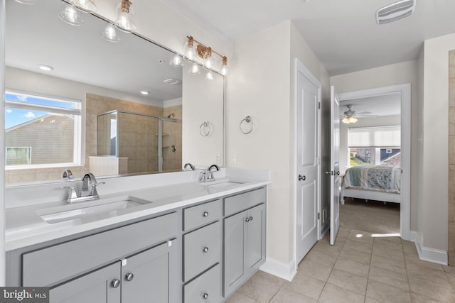 bathroom featuring ceiling fan, vanity, tile patterned flooring, and an enclosed shower