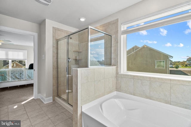 bathroom with ceiling fan, plenty of natural light, tile patterned flooring, and shower with separate bathtub