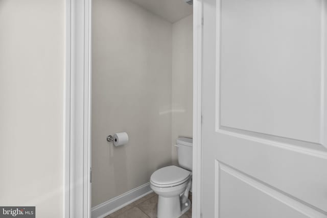 bathroom with toilet and tile patterned floors