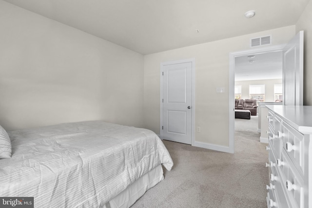 bedroom featuring light carpet