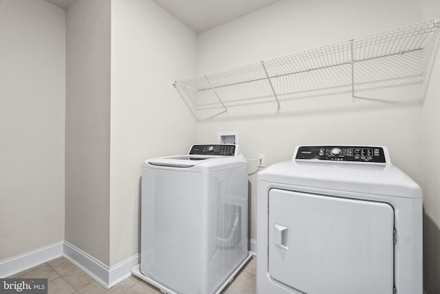 washroom featuring light tile patterned floors and washer and dryer