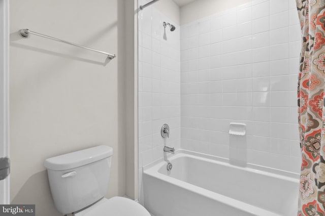 bathroom with shower / tub combo and toilet