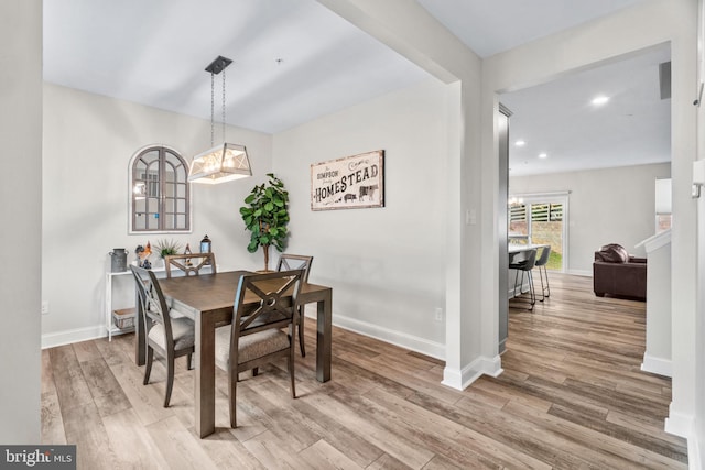 dining room with wood-type flooring