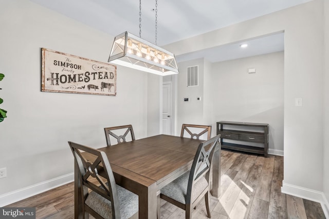 dining space with hardwood / wood-style flooring