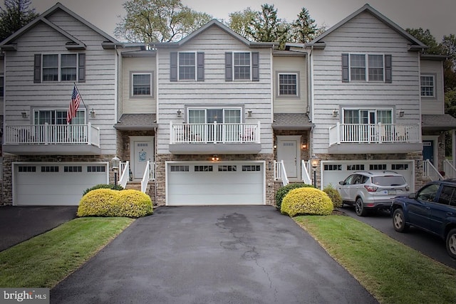 view of front of house featuring a balcony and a garage