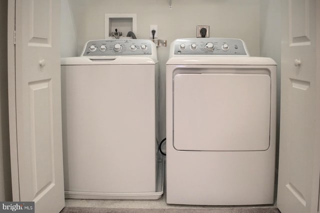 laundry room featuring washing machine and clothes dryer