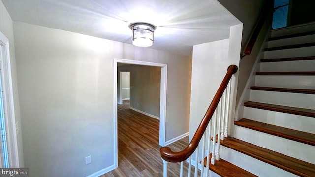 stairs featuring hardwood / wood-style flooring