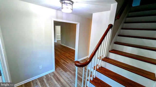 stairway featuring hardwood / wood-style flooring