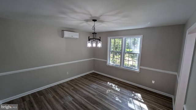 empty room with an inviting chandelier, dark hardwood / wood-style flooring, and a wall unit AC