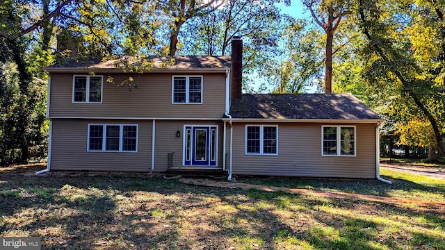 rear view of property featuring a yard