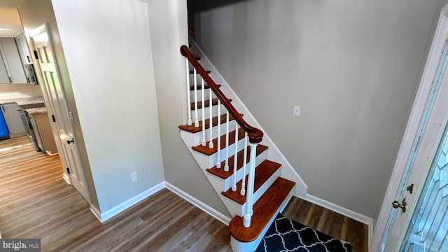 stairs featuring hardwood / wood-style floors