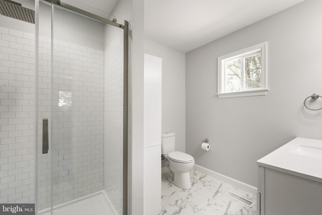 bathroom featuring a shower with shower door, vanity, and toilet