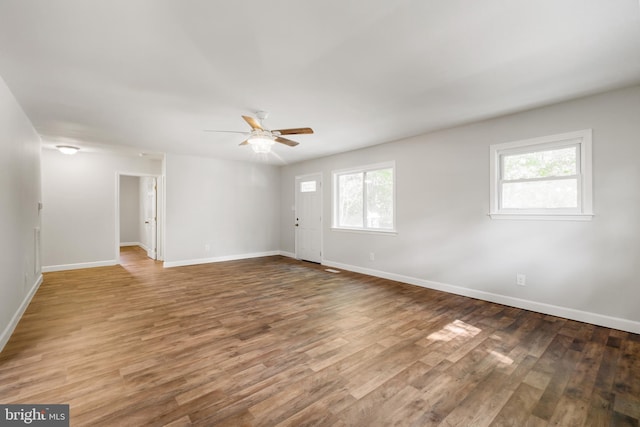 unfurnished room with hardwood / wood-style flooring and ceiling fan