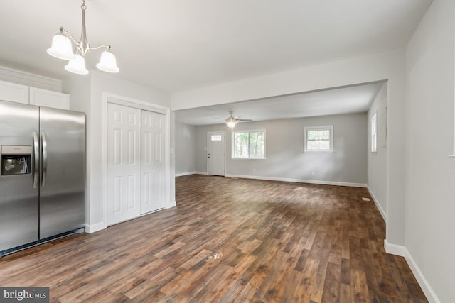 kitchen featuring white cabinets, pendant lighting, stainless steel refrigerator with ice dispenser, dark hardwood / wood-style floors, and ceiling fan with notable chandelier