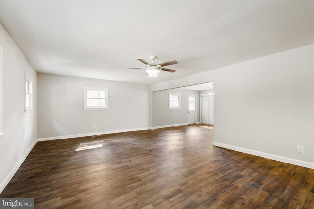 unfurnished room with ceiling fan and dark hardwood / wood-style flooring