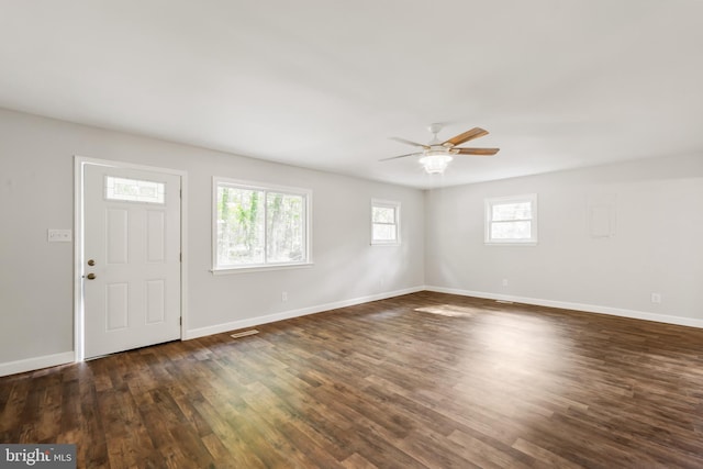 entrance foyer featuring ceiling fan, dark wood-type flooring, and a healthy amount of sunlight