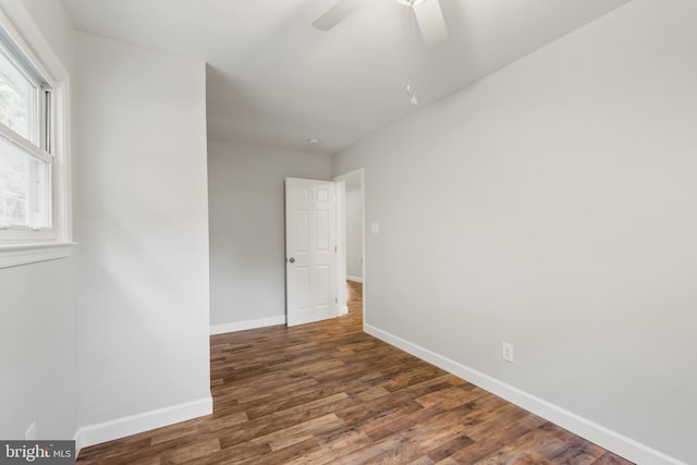 unfurnished room featuring ceiling fan and dark hardwood / wood-style floors