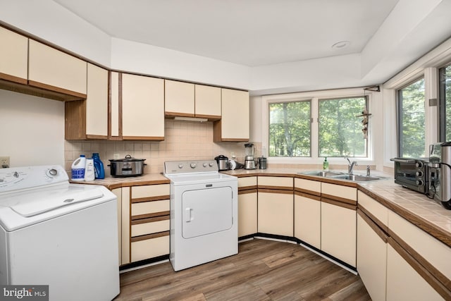 laundry room featuring sink and dark hardwood / wood-style flooring