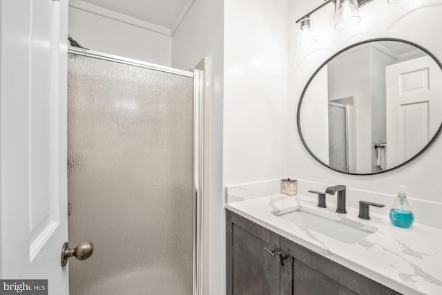 bathroom with walk in shower and vanity