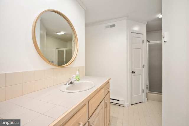 bathroom with vanity, baseboard heating, and a shower with door