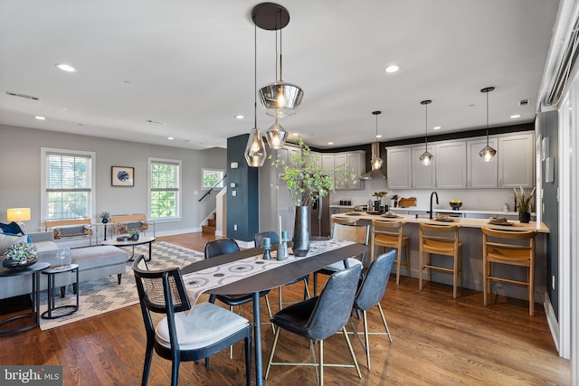 dining room featuring sink and wood-type flooring