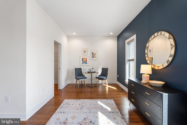 sitting room with dark hardwood / wood-style flooring