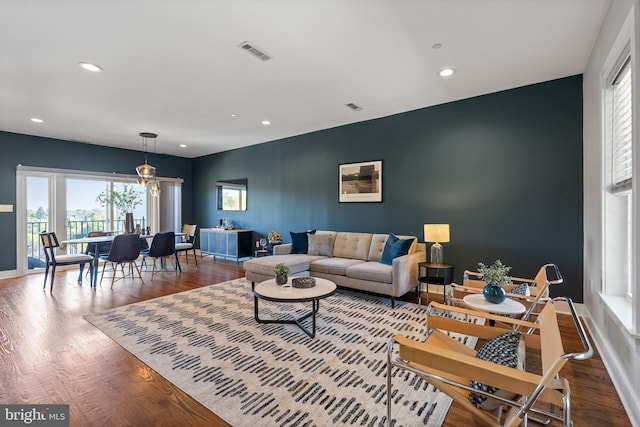 living room with a healthy amount of sunlight and hardwood / wood-style floors