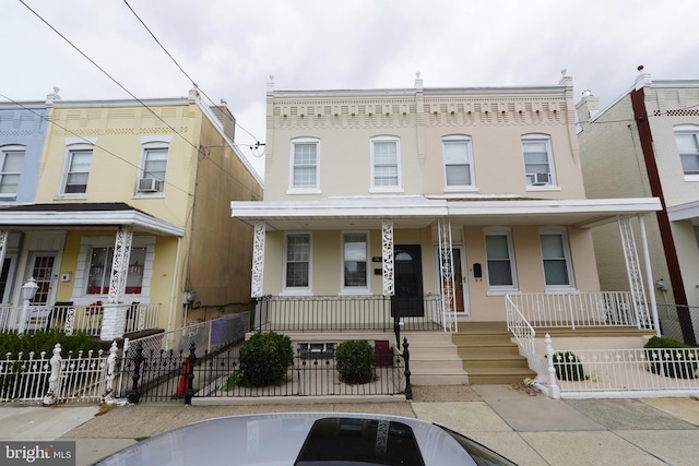 townhome / multi-family property featuring a porch