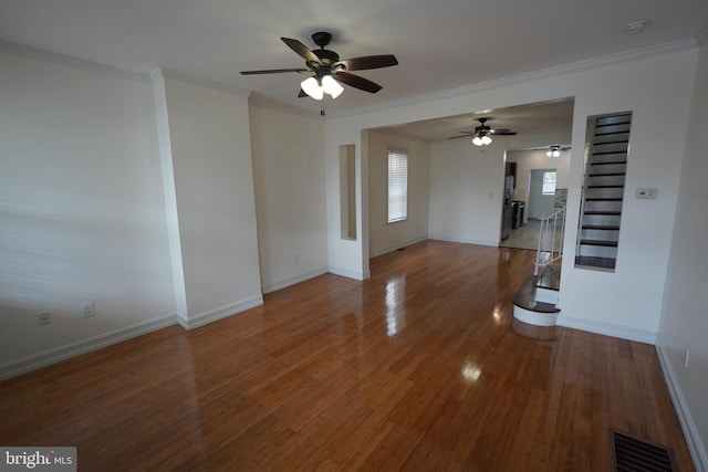 unfurnished room with wood-type flooring, crown molding, and ceiling fan