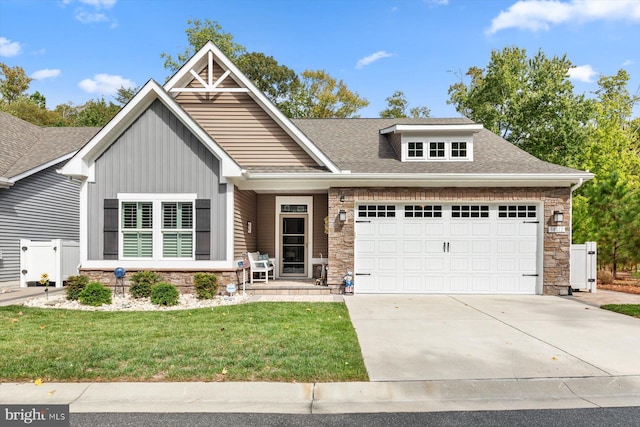 craftsman inspired home featuring a garage and a front lawn