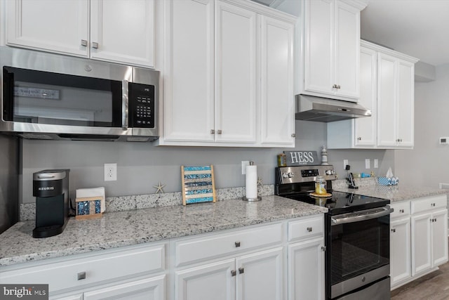 kitchen with wood-type flooring, ventilation hood, white cabinetry, stainless steel appliances, and light stone countertops