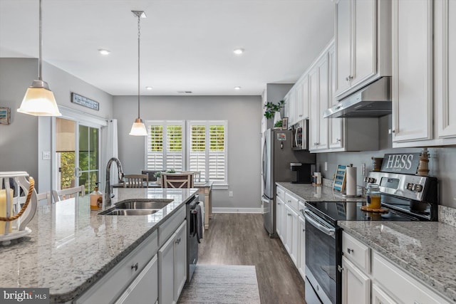 kitchen featuring white cabinets, pendant lighting, sink, stainless steel appliances, and dark hardwood / wood-style flooring