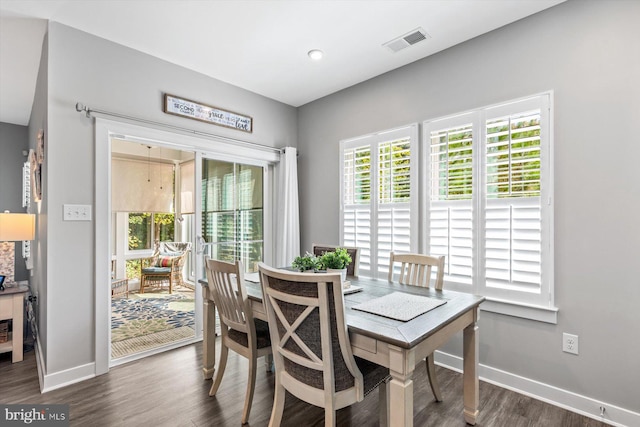 dining room with dark hardwood / wood-style flooring