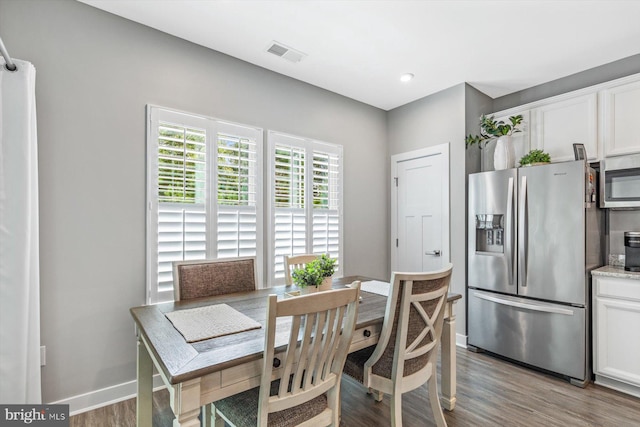 dining space with light wood-type flooring