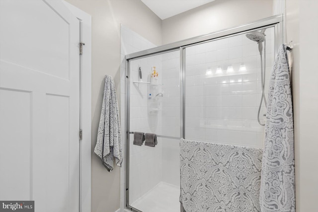 bathroom with a shower with door