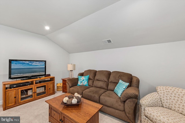 living room with vaulted ceiling and light colored carpet