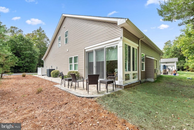 view of side of property featuring a patio and a yard