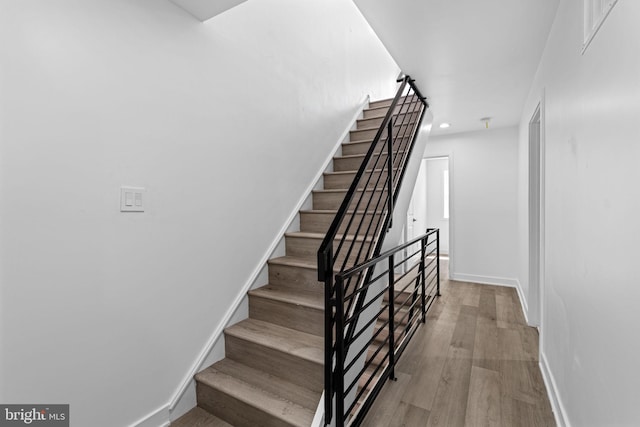 stairs with wood-type flooring