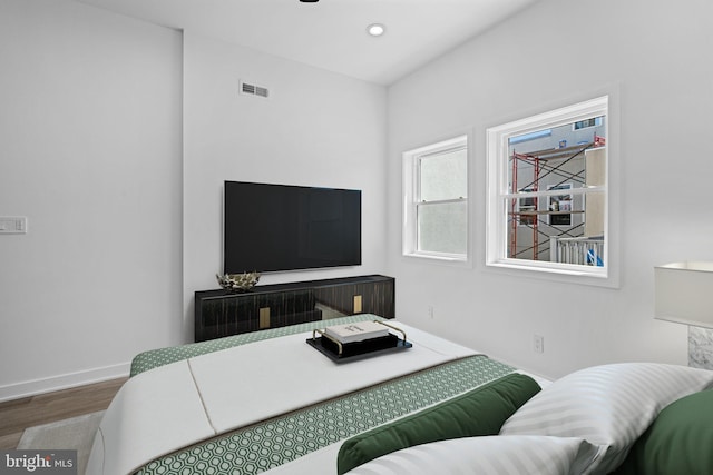 bedroom with hardwood / wood-style flooring