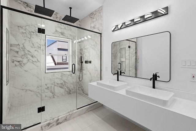 bathroom featuring vanity, a shower with shower door, and tile patterned floors