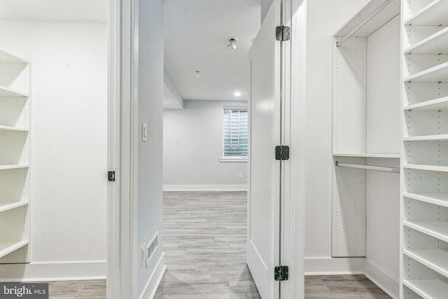 spacious closet featuring light hardwood / wood-style flooring