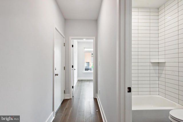 hallway with dark hardwood / wood-style flooring