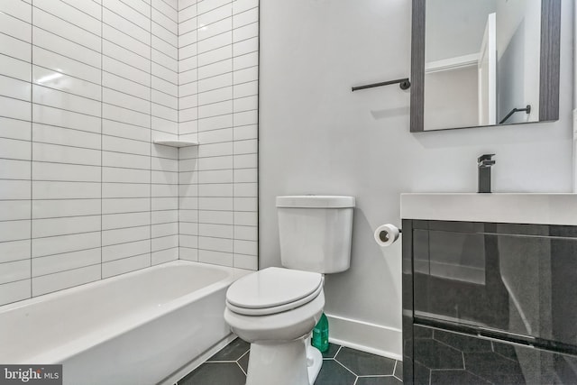 full bathroom with tile patterned floors, vanity, tiled shower / bath combo, and toilet