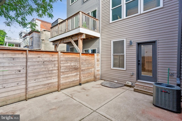 view of patio / terrace with central AC unit and a balcony