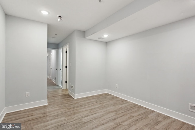 empty room with light hardwood / wood-style flooring