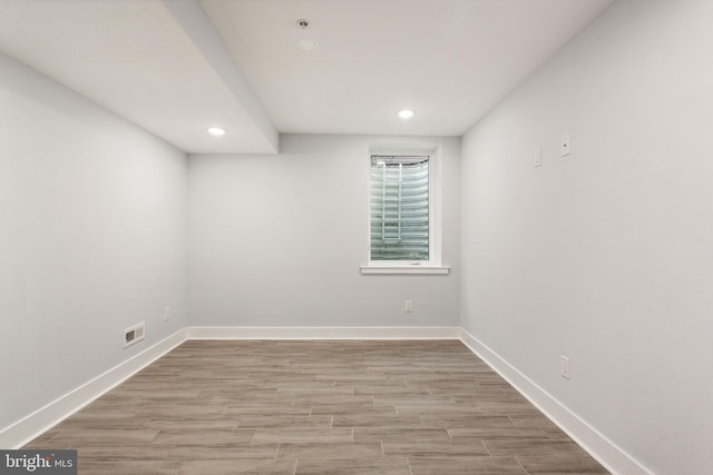 spare room with light hardwood / wood-style flooring