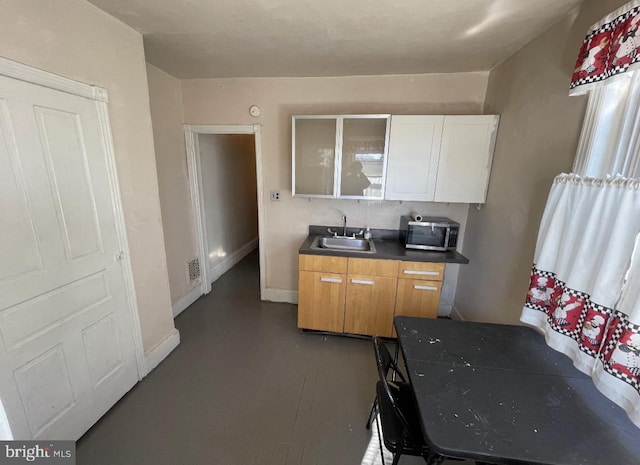 kitchen featuring sink and dark wood-type flooring