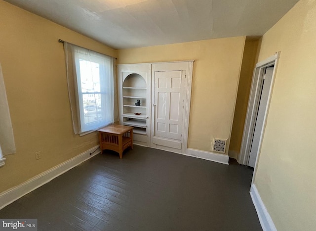 unfurnished bedroom with dark hardwood / wood-style floors