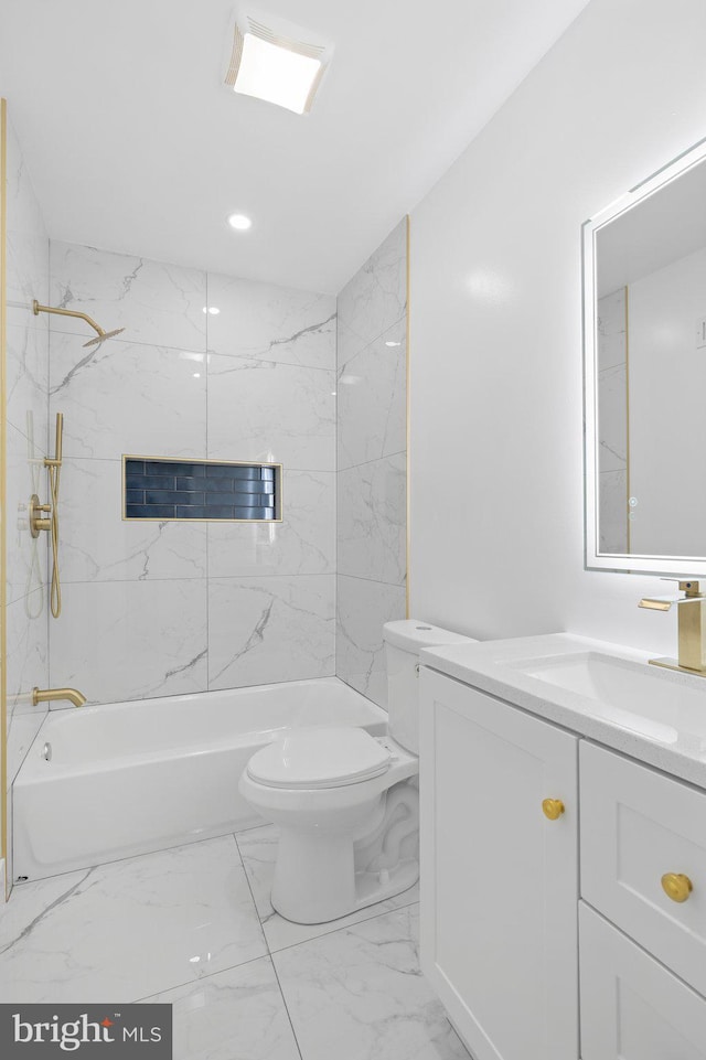 full bathroom featuring tiled shower / bath, vanity, and toilet