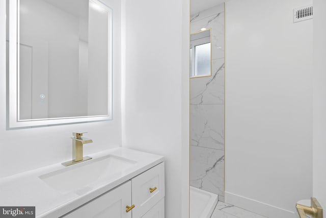 bathroom with a shower and vanity